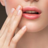 Part of woman's face. Woman's lips, nose and hand. Soft skin.
